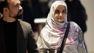 Iranian citizen Mahdieh Esfandiari arrives with a lawyer for her trial on charges of promoting terrorism on social media at a Paris court. AFP