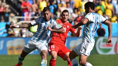 Switzerland midfielder Granit Xhaka,centre, Argentina defenders Marcos Rojo,left, and Ezequiel Garay, right vie for the ball during their match on Tuesday at the 2014 World Cup. Nelson Almeida / AFP