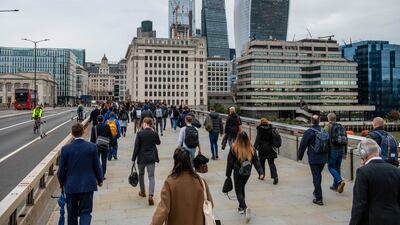 Commuters make their way over London Bridge towards the City of London. Bloomberg