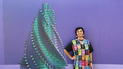Monira Al Qadiri poses next to one of the hoardings using her work for Abu Dhabi Art's visual campaign. Pawan Singh / The National