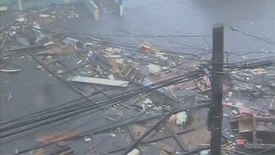 Debris float on a flooded road as strong winds and rain continue to batter buildings after Typhoon Haiyan hit Tacloban city, Leyte province. ABS-CBN via Reuters