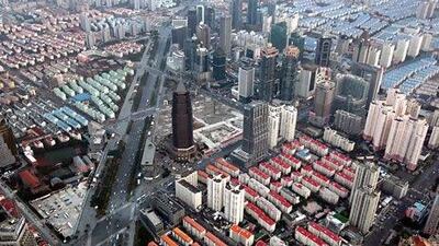 Residential and commercial buildings stand in the Pudong area of Shanghai, China, on Saturday, Feb. 2, 2013. China's economic growth accelerated for the first time in two years as government efforts to revive demand drove a rebound in industrial output, retail sales and the housing market. Photographer: Tomohiro Ohsumi/Bloomberg