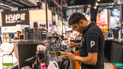 A barista at Coffee Planet prepares coffee for customers at the Gulfood exhibition at the Dubai Trade Center. Alex Atack / The National.