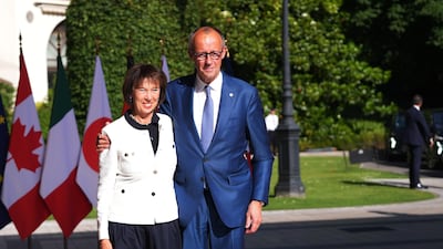 Mr Merz arrives at the summit with his wife Charlotte. Bloomberg