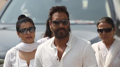 Indian Bollywood actor Ajay Devgan, cente, and his wife Kajol, left, were amongst the celebrity mourners. Punit Paranjpe / AFP Photo