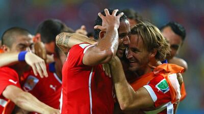 Jean Beasejour of Chile, left, celebrates with teammates after scoring the final goal in a 3-1 win over Australia at the 2014 World Cup on Friday. Clive Brunskill / Getty Images