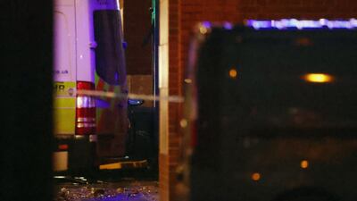 Debris can be seen from the front end of a car which crashed into the Edmonton Police Station. Reuters