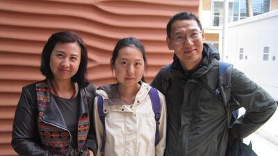 Yixing Wang, centre, and her parents Yali Li, left, and Lei Wang at the UAE Pavillion. Daniel Bardsley for The National