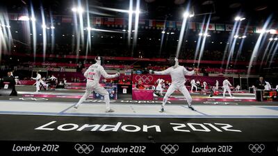 Cao Zhongrong of China, left, and Ondrej Polivka of the Czech Republic compete during the fencing section of the men's modern pentathlon. Kirsty Wigglesworth/AP Photo