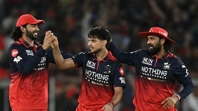 Royal Challengers Bengaluru's Rasikh Dar, centre, picked up three wickets in on Sunday. AFP