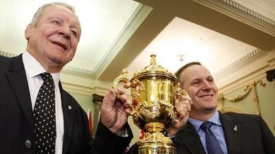 John Key, the New Zealand prime minister, right, and Bil Beaumont, IRB deputy chairman, hold one of the Webb Ellis trophies. New Zealand world cup organisers admitted that there are two cups, one a duplicate.