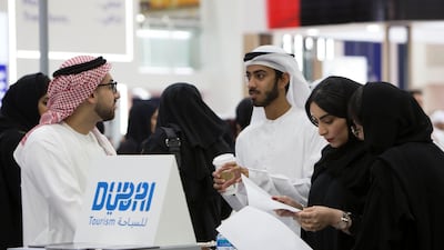 Emirati jobseekers speak to recruiters at Careers UAE at Dubai World Trade Centre. Leslie Pableo for The National