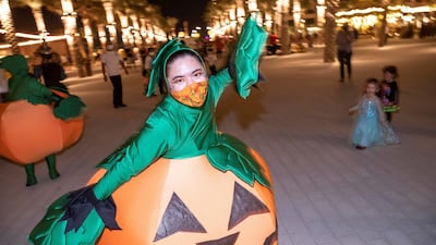 Halloween performers dance and scare visitors at the Town Square Halloween event in Dubai.