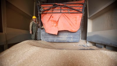 A workers watches as wheat is stored in a grain silo at Jwaideh, near Jordan's capital Amman. Salah Malkawi for The National