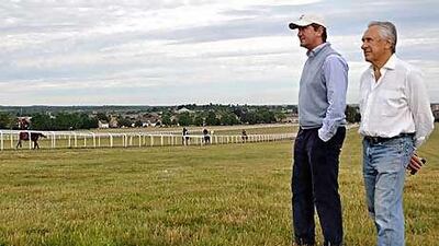 Bruce Raymond on Warren Hill, watching his horses go through their paces with David Simock, one of 19 trainers employed by Rabbah Bloodstock.