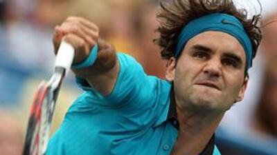 Roger Federer serves against Novak Djokovic on his way to victory in Cincinnati.