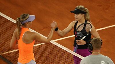 Eugenie Bouchard, right, greets Maria Sharapova at the net after their match at the Madrid Open on Monday. Julian Finney / Getty Images