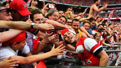 Jack Wilshere of Arsenal celebrates victory with fans after the FA Cup with Budweiser Final match between Arsenal and Hull City at Wembley Stadium in London, England. Shaun Botterill / Getty