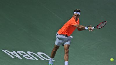 Roger Federer returns a shot to Mikhail Youzhny on Monday at the ATP Dubai Duty Free Tennis Championships. Kamran Jebreili / AP