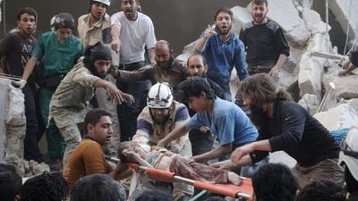 Syrian rescue workers and citizens carry a child on a stretcher who was injured following a reported barrel bomb attack by Syrian government forces at the Al-Firdaws neighbourhood, Aleppo, Syria. Karam Al-Masri / AFP
