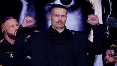Oleksandr Usyk poses on the stage. Reuters