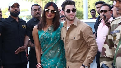 Priyanka Chopra and Nick Jonas pose for photographs as they walk in to Jodhpur Airport after their weekend of wedding ceremonies. EPA
