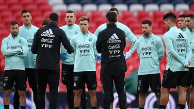 Lionel Messi listens to Argentina head coach Lionel Scaloni. Getty Images