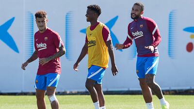 Barcelona players Philippe Coutinho, left, Ansu Fati and Memphis Depay. EPA