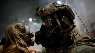 Federal officers use chemical irritants and crowd control munitions to disperse Black Lives Matter protesters in Portland. AP