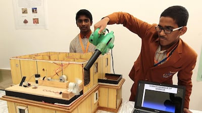 Abdulla Shehin and Stanley James, both 15, and Grade 10 pupils of Gulf Asian English School, Sharjah, show their project, Emergency Hydro Power Plant, during the annual Medical and Science Exhibition at the Gulf Medical University in Ajman. Jeffrey E Biteng / The National