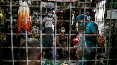 An election official is seen in a residence in Yangon last week, as advance voting in the country's elections began for elderly people. AFP
