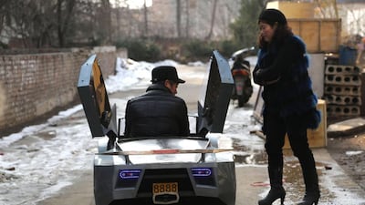 Guo, left, a farmer in his 50s, sits in his self-made scale replica of a Lamborghini.