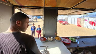 Mohammed Al Amarin gets ready to hand out slices of pizza from his mobile kitchen. Mohammed Abu Amra for The National