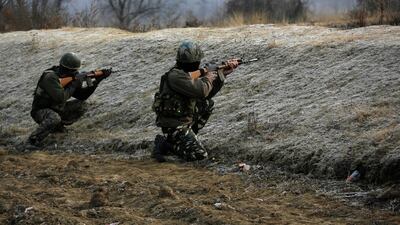 Indian soldiers take position outside a paramilitary camp at Lethpora village in Indian-controlled Kashmir that was stormed by rebels on December 31, 2017. Mukhtar Khan / AP Photo