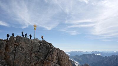 Tourists gather around the cross on top of the Zugspitze, Germany's highest mountain, in Grainau, near Garmisch-Partenkirchen, southern Germany. AFP