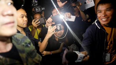 Journalists smile as they try to interview a military officer near the Tham Luang cave complex, as members of an under-16 soccer team and their coach have been found alive, according to a local media's report, in the northern province of Chiang Rai, Thailand, on July 2, 2018. Soe Zeya Tun / Reuters