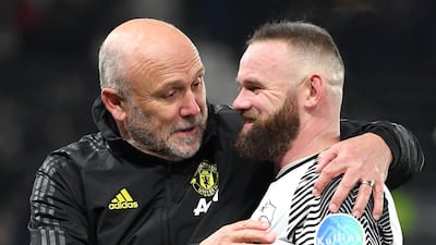 United coach Mike Phelan with Wayne Rooney. Getty