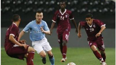 Qatar's Saleh Badr, right, and Manchester City's Albert Rusnak in action.