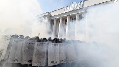 Smoke rises from the parliament building in Kiev as activists of radical Ukrainian parties, including the Ukrainian nationalist party Svoboda (Freedom), clash with police officers. Sergei Supinsky / AFP Photo