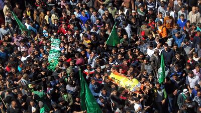 Palestinians carry bodies during the funeral of three Palestinians: Yazan Basim, Mahmoud Abu Zena and Hamza Abu Al Haija at Jenin Refugee Camp in Jenin, West Bank on March 22. Three Palestinians were killed and at least nine wounded during clashes with Israeli forces. Alaa Badarneh / EPA