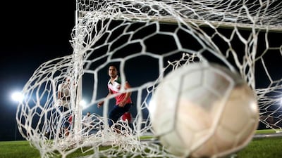 Workers play football on the outdoor lawn. Christopher Pike / The National