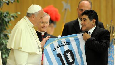 Pope Francis meets football legend Diego Maradona during an audience in Rome in September 2014. Getty Images