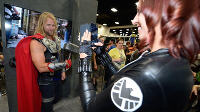 An attendee dressed as Black Widow takes picture of Thor at the Legendary Entertainment booth at Comic-Con International 2013. Jeff Bottari / Invision for LG / AP Images
