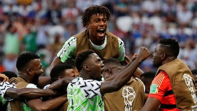 Nigeria players including Alex Iwobi, top, celebrate Ahmed Musa's first goal. Toru Hanai / Reuters
