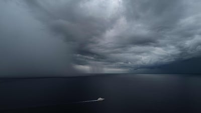 A yacht sails ahead of an approaching rainstorm over The Mediterranean Sea, near Nice, southern France. AFP