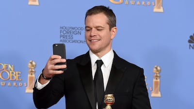 Matt Damon poses in the press room with the award for best performance by an actor in a motion picture — musical or comedy for The Martian at the 73rd annual Golden Globe Awards. Jordan Strauss / Invision / AP