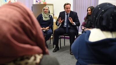Britain's Prime Minister David Cameron, center, meets women attending an English language class during a visit to the Shantona Women's Centre in Leeds. Oli Scarff / AP