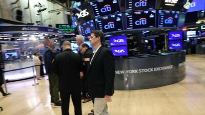 Traders work on the floor of the New York Stock Exchange on Friday as the Dow surged by more than 450 points on Friday to a record high. Getty Images/AFP