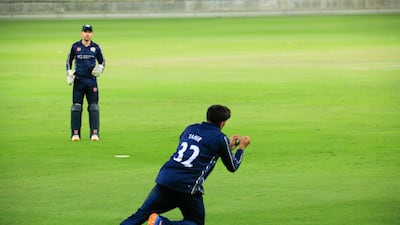 Hamza Tahir takes the match-winning catch for Scotland against Oman. Photo: ICC