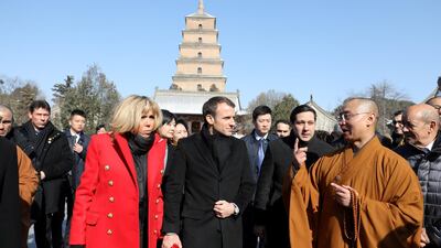 French President Emmanuel Macron and his wife Brigitte Macron listen to a priest during a visit to the Big Wild Goose Pagoda in the northern Chinese city of Xian, China. Ludovic Marin / Reuters
